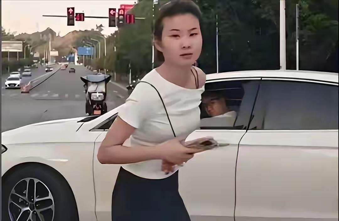 这娘们真大胆，好好的路口，直接堵在人家车头，你过去了跟别人道个歉不就行了，还对着
