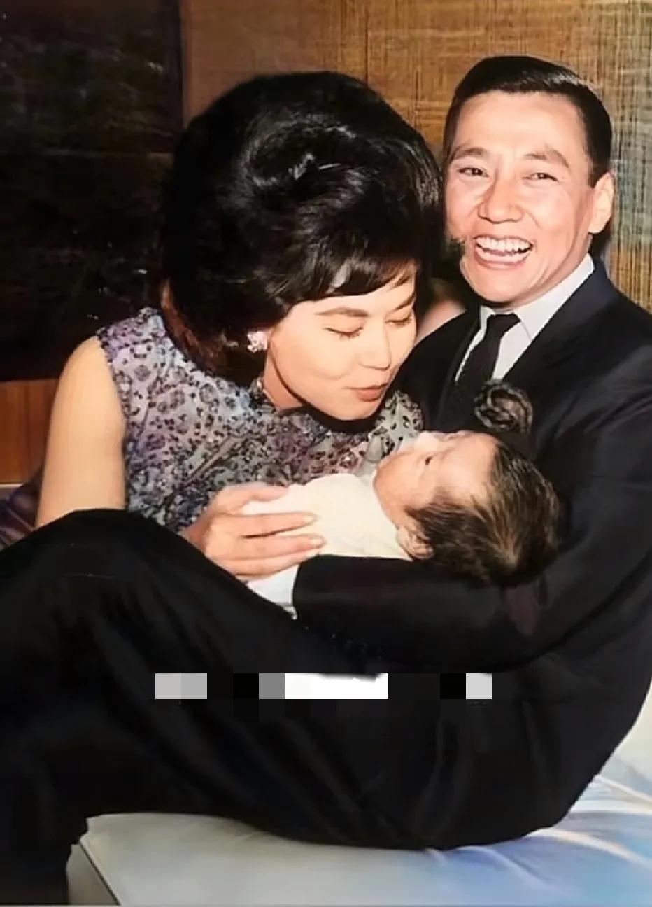 1963年，林黛和丈夫龙绳勋以及襁褓中的儿子龙宗瀚的留影，镜头中林黛准备俯身去亲