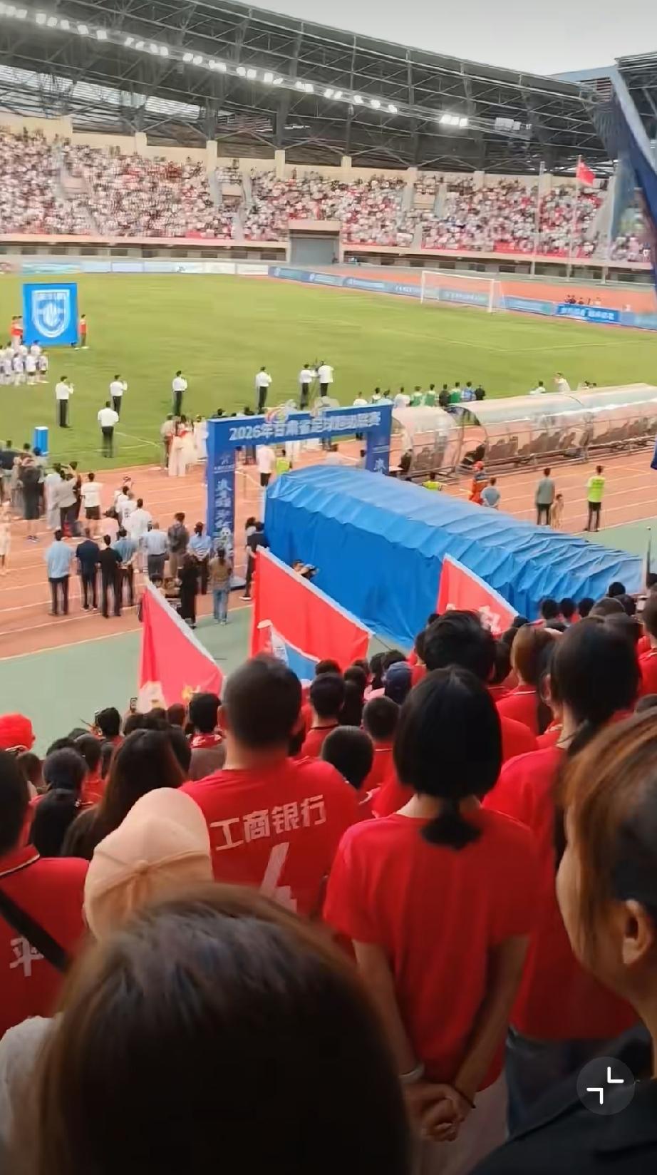 陇超比赛现场奏国歌全场肃立，唯有一位持证工作人员坐在场边跷着腿玩手机引众怒！！