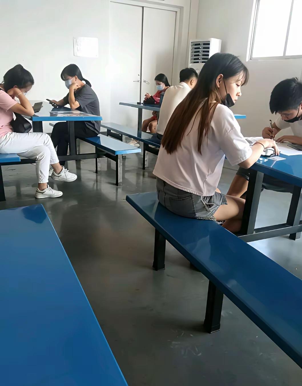 工厂招聘，长发女生低头认真填写资料 女工招工 本科女生求职 工厂员工招聘 大龄女