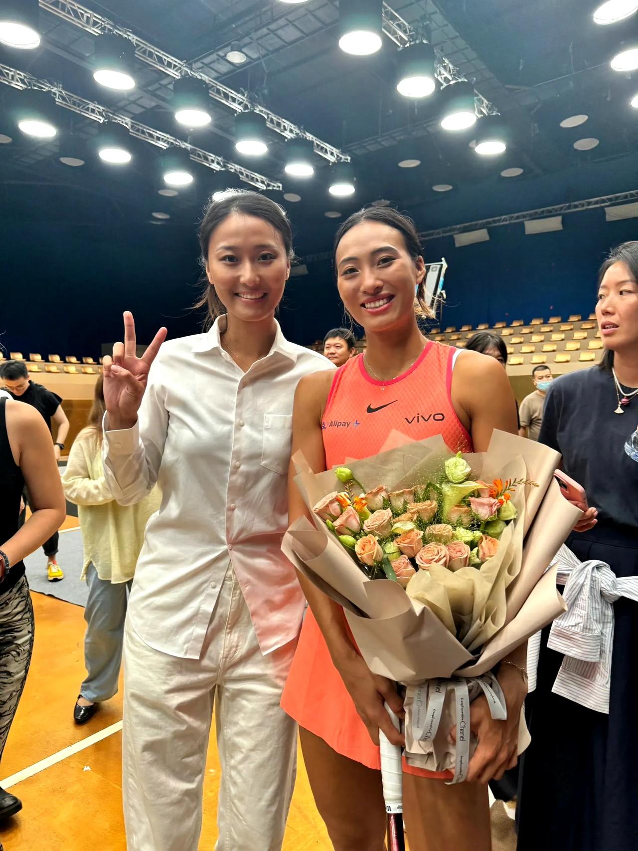和郑钦文手捧鲜花，笑容灿烂的和身边的女孩合照！怎么感觉她旁边的姑娘和郑钦文长的这
