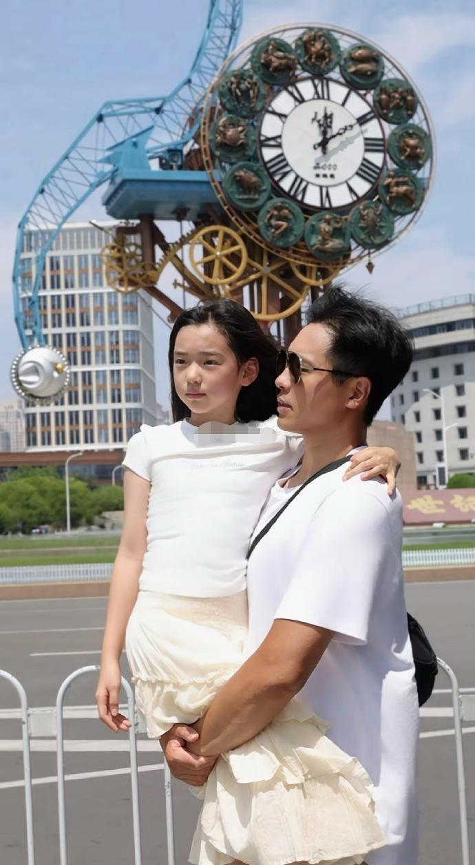 10 岁的小酒窝在社交平台发布了与爸爸高云翔在‌天津解放桥‌的合照，并拼接了幼年