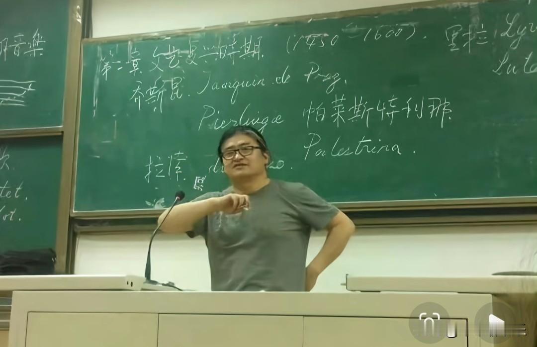 这是刘欢在对外经贸大学教学时的照片，
他身着简单的T恤衫，身后是手写的板书。
他