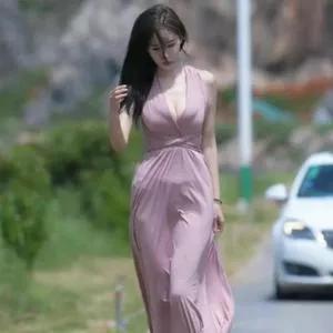 海边漫步，粉色长裙飘逸，自然美景相伴。