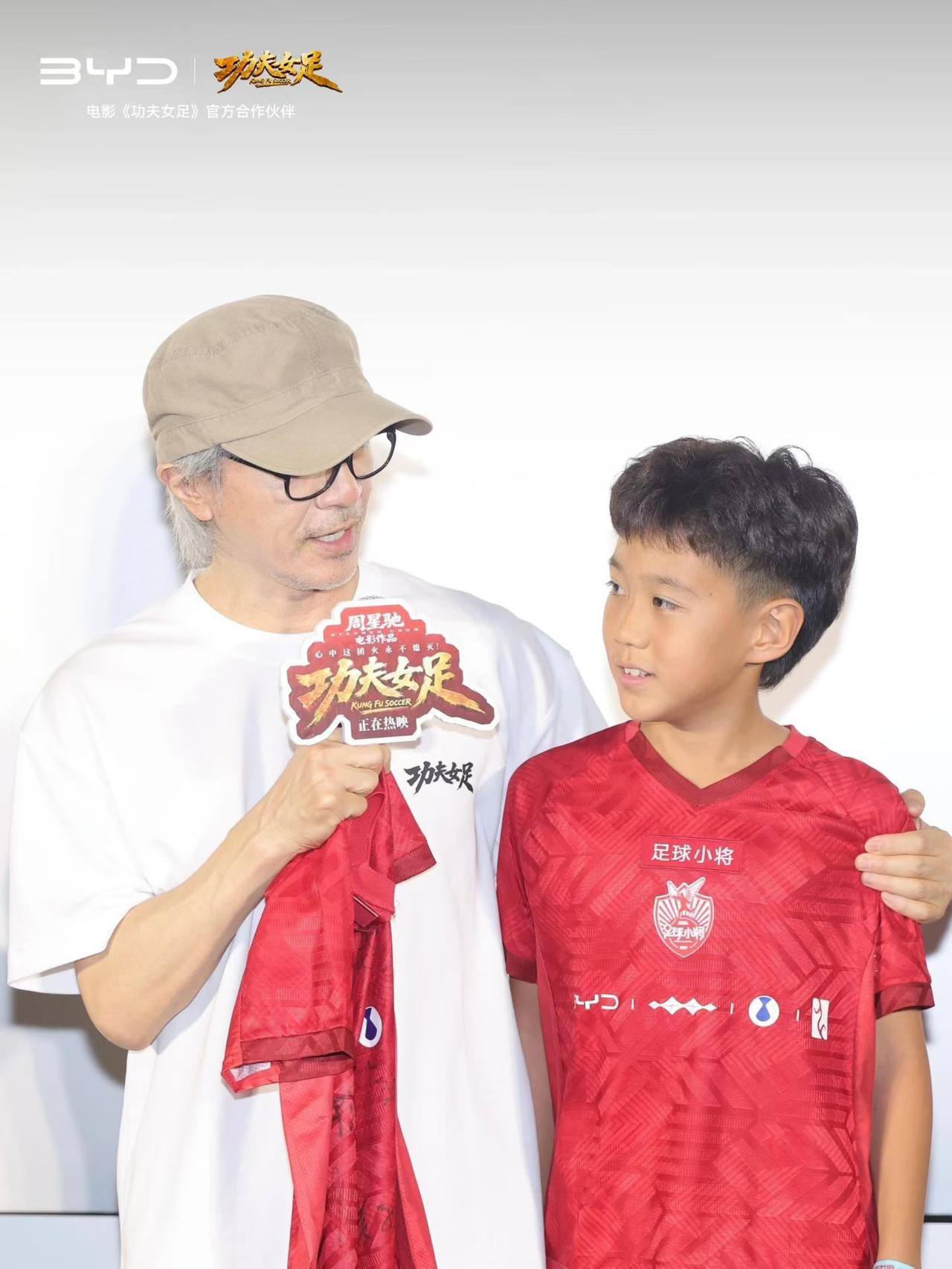 厉害了！比亚迪护送足球小将亮相周星驰电影《功夫女足》路演，星爷赠言:“未来世界冠