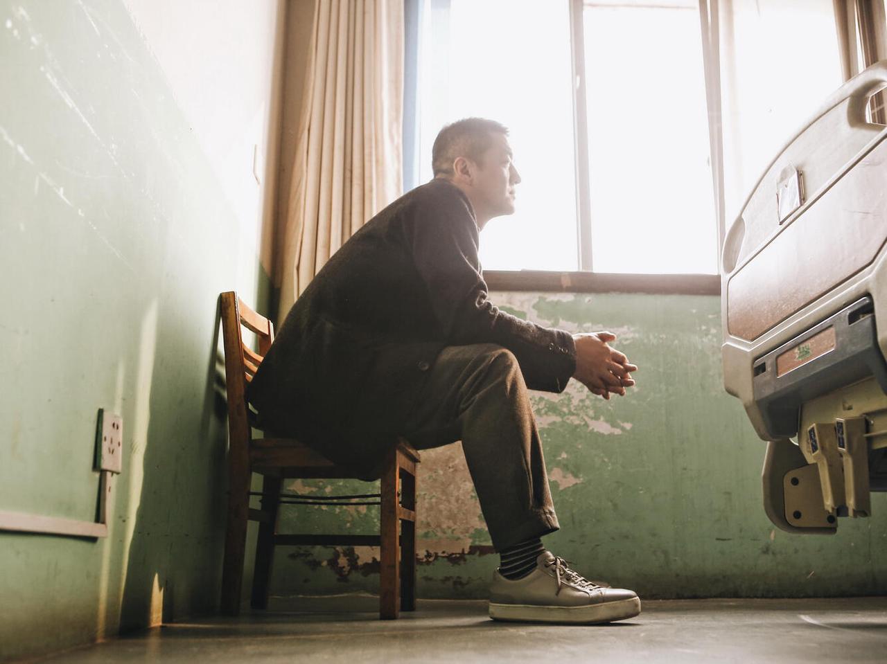 偶然刷到了李亚鹏的这组照片。

照片里李亚鹏独自坐在墙角，像一个父亲正为自己的女
