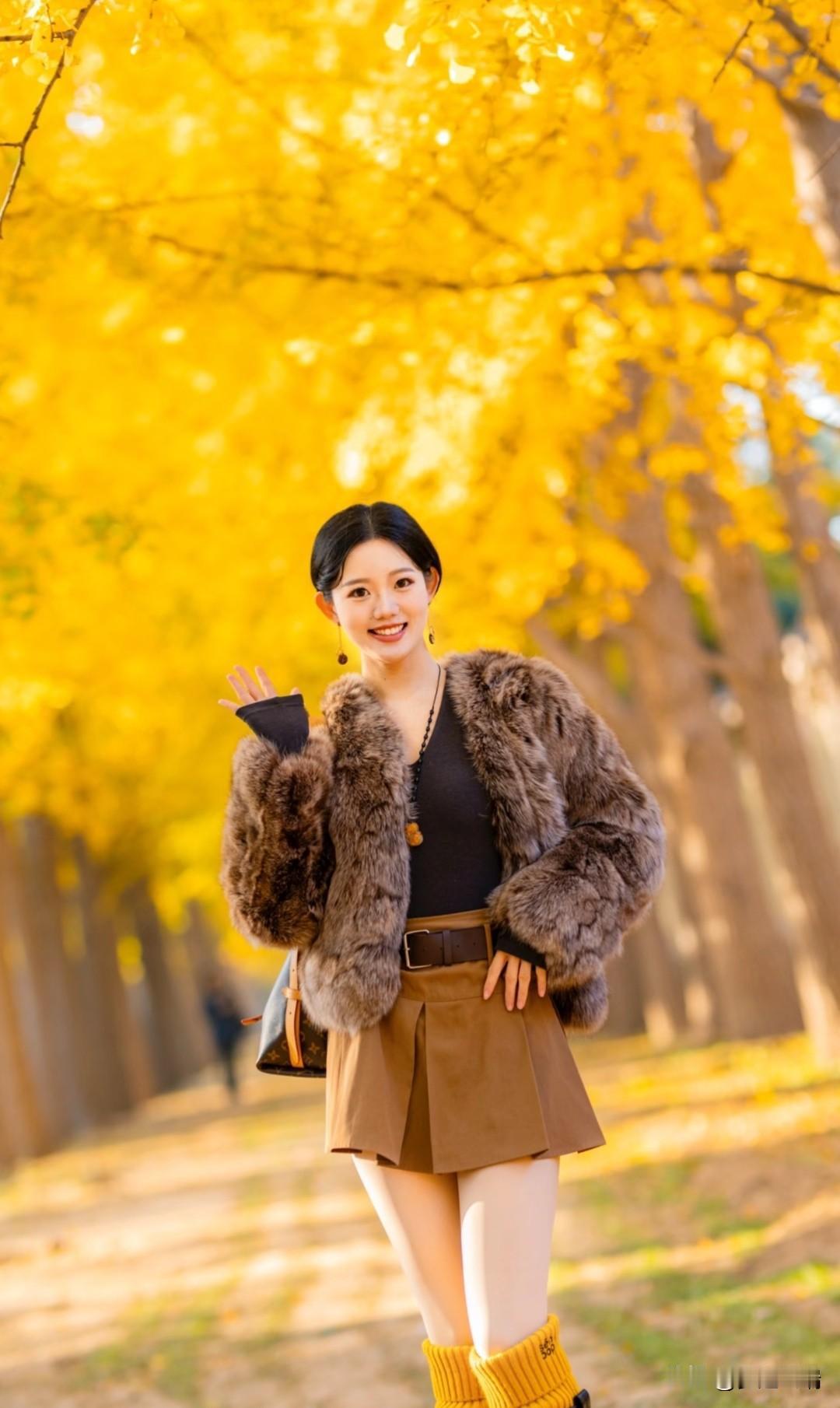 秋日暖阳下，笑靥如花的她，漫步在金黄的银杏林间。
