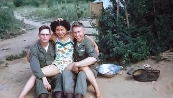 1952年，一名南朝鲜女子给两名美军做完服务后，当着老公的面热情地送大兵们离开。