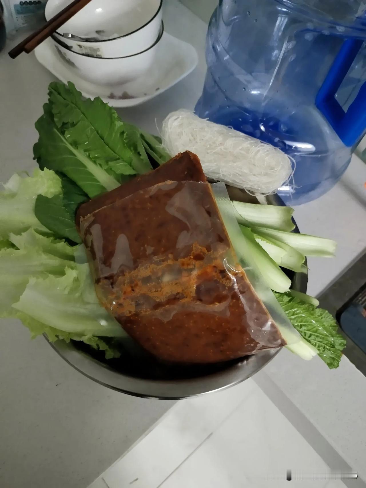 房东的冰箱里还有火锅底料，一袋冻豆腐，一袋裙带菜，几个丸子，还有粉丝。
我想给他