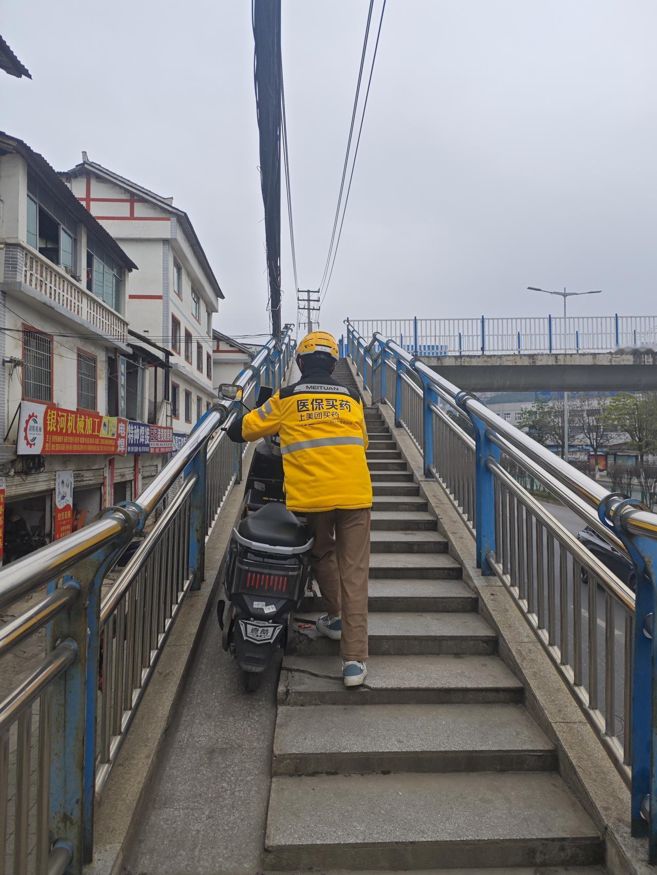 生活，对谁都不易！贵阳，一外卖小哥要到对面马路去取餐，要顺着路骑行又太远，只能推