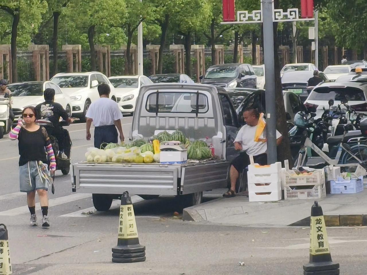 路边卖瓜也许是他一家人的生机。
只要他不妨碍交通，不搞得脏乱差，也是和谐的一景。