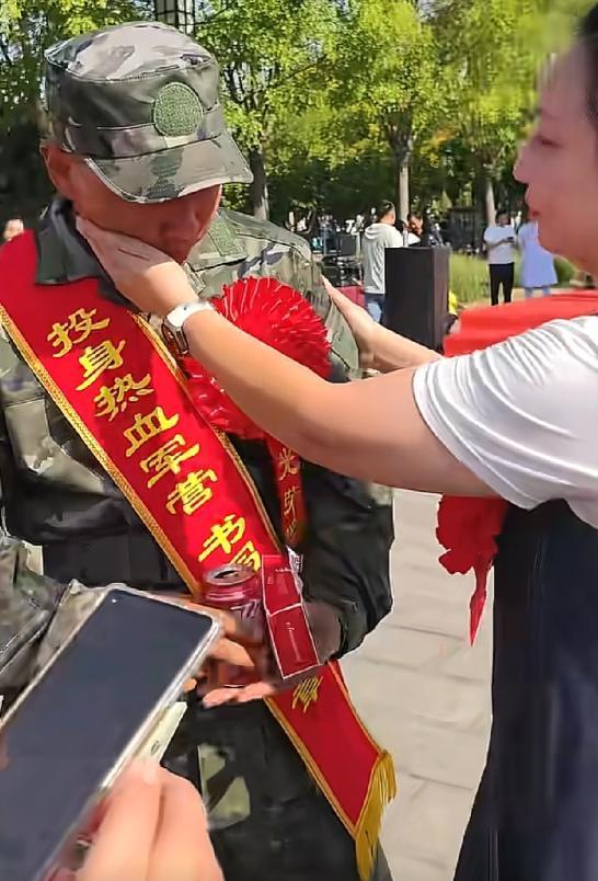 4名女子，围在一位入伍新兵身旁，一名女子抚摸着小伙子的脸庞，说出的一个称呼，让新