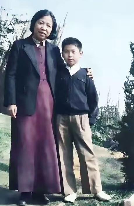 这是一张上色修复老照片，图中少年是少年时期的李鹏（原名李远芃），身旁的是邓颖超。