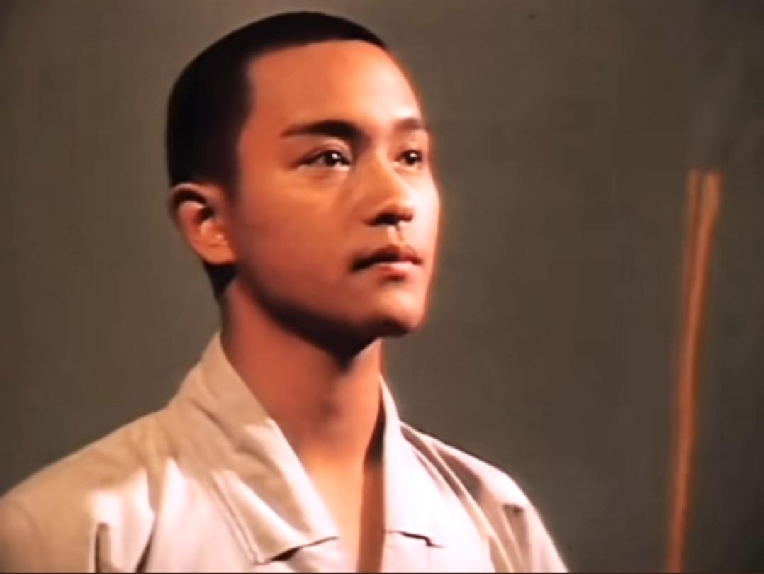 一个年轻男子看着远方，背景简单。那时候真年轻啊？精神小伙，还有人记得他吗？