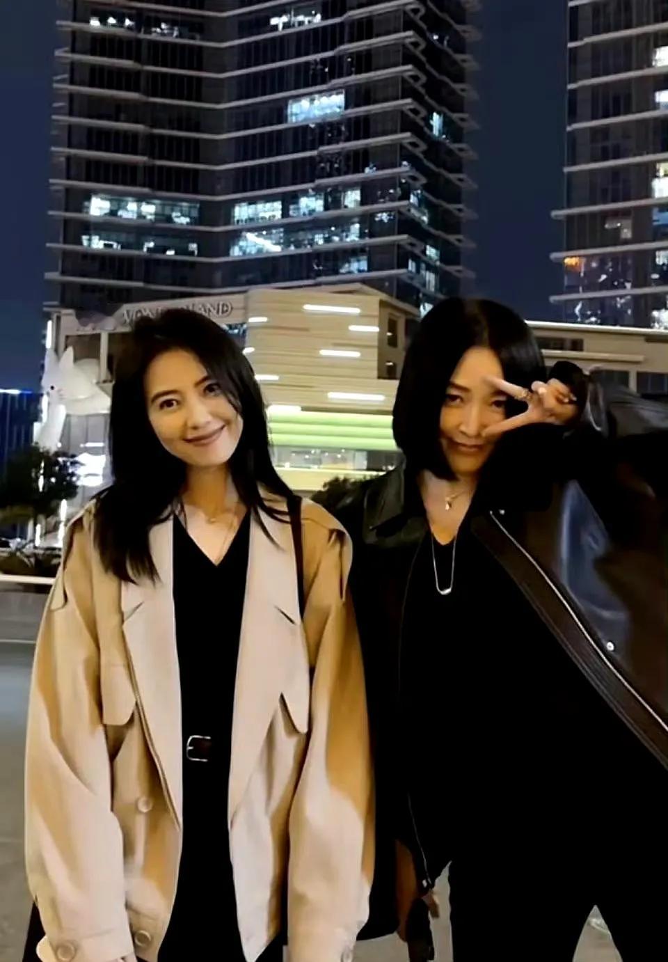 夜幕下的夜晚，霓虹灯璀璨！她们俩在这五彩的夜色中快乐的合照！照片中的她俩，左边的