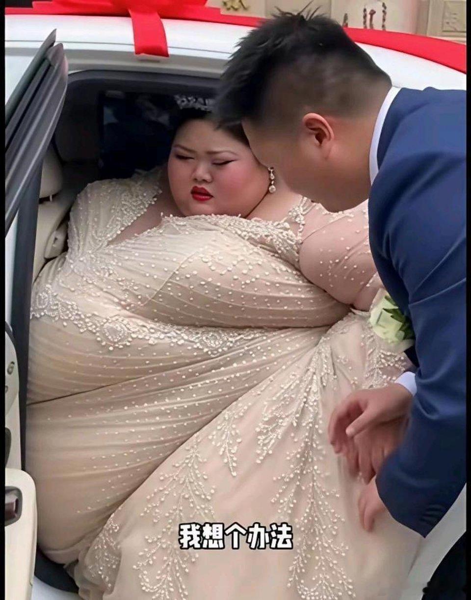 新娘穿着漂亮的婚纱满满地挤在后座里，整个身子被牢牢困住，想出来根本无从下手，脸上