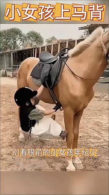 小女孩上马背。
朋友们快来看，别看眼前的小女孩年纪小，但是她却是一个骑马高手。在