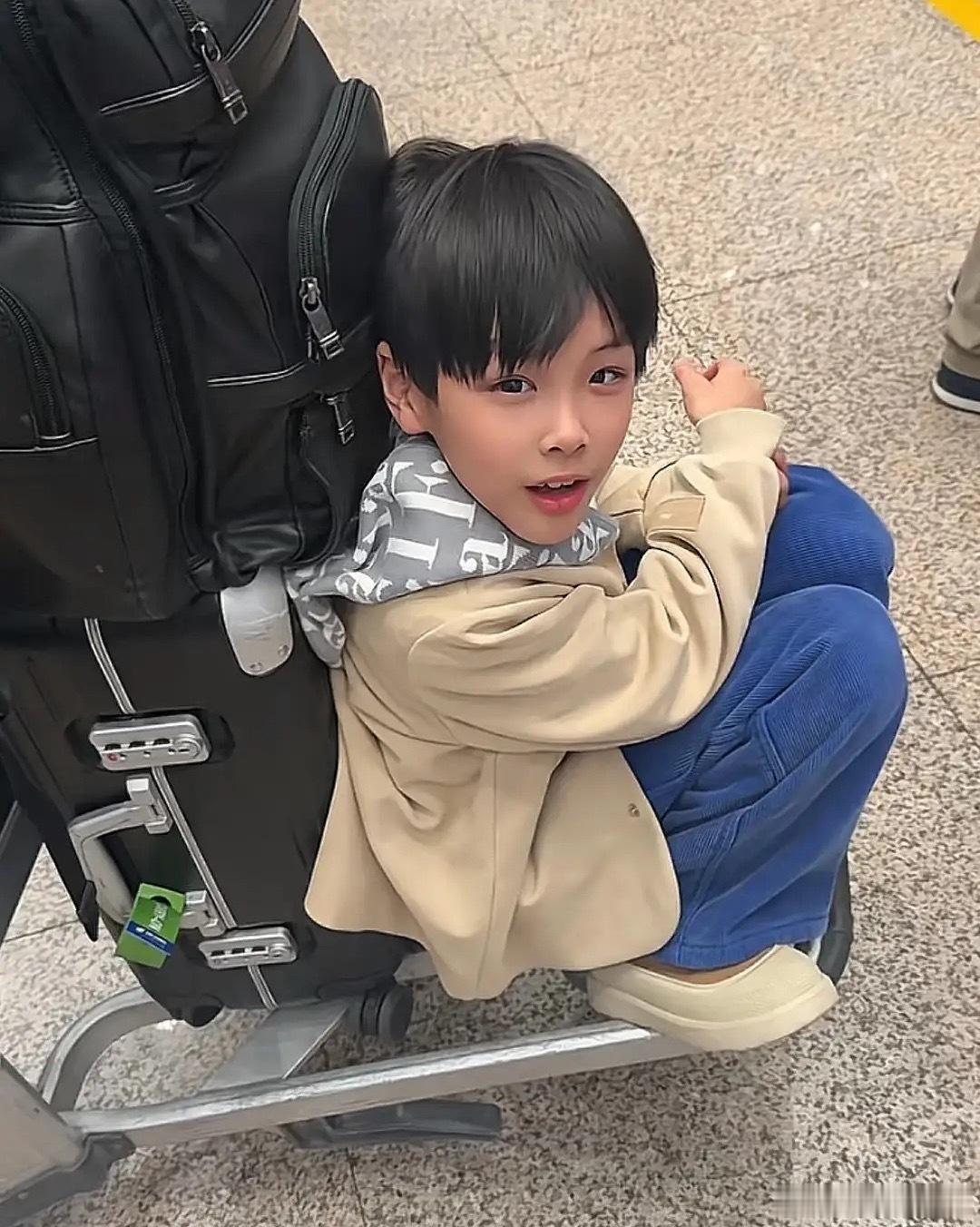 杨子一个人带着两个儿子出门度假，9岁小儿子杨安麟小v脸，双眼皮，长得很像妈妈黄圣