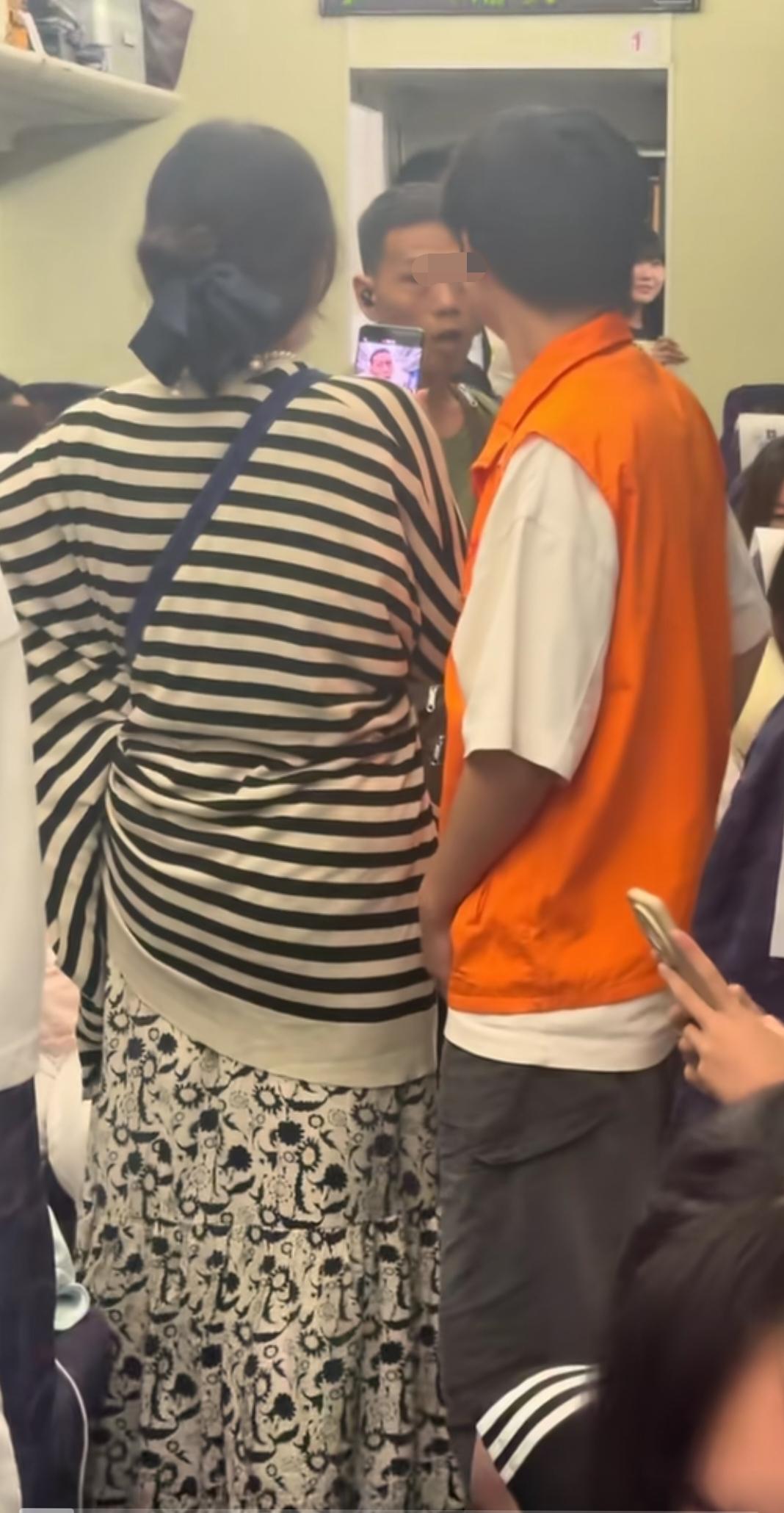 绿皮火车上，男子在车厢连接处抽烟，这个穿条纹上衣的女士看不下去了，上去质疑人家: