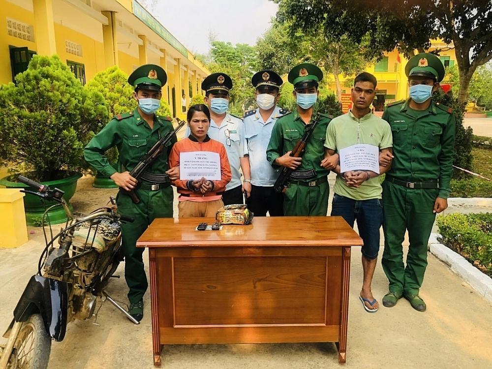 越南海关与边防部队人员抓获的毒品走私人员，摩托车也被拆成了架子