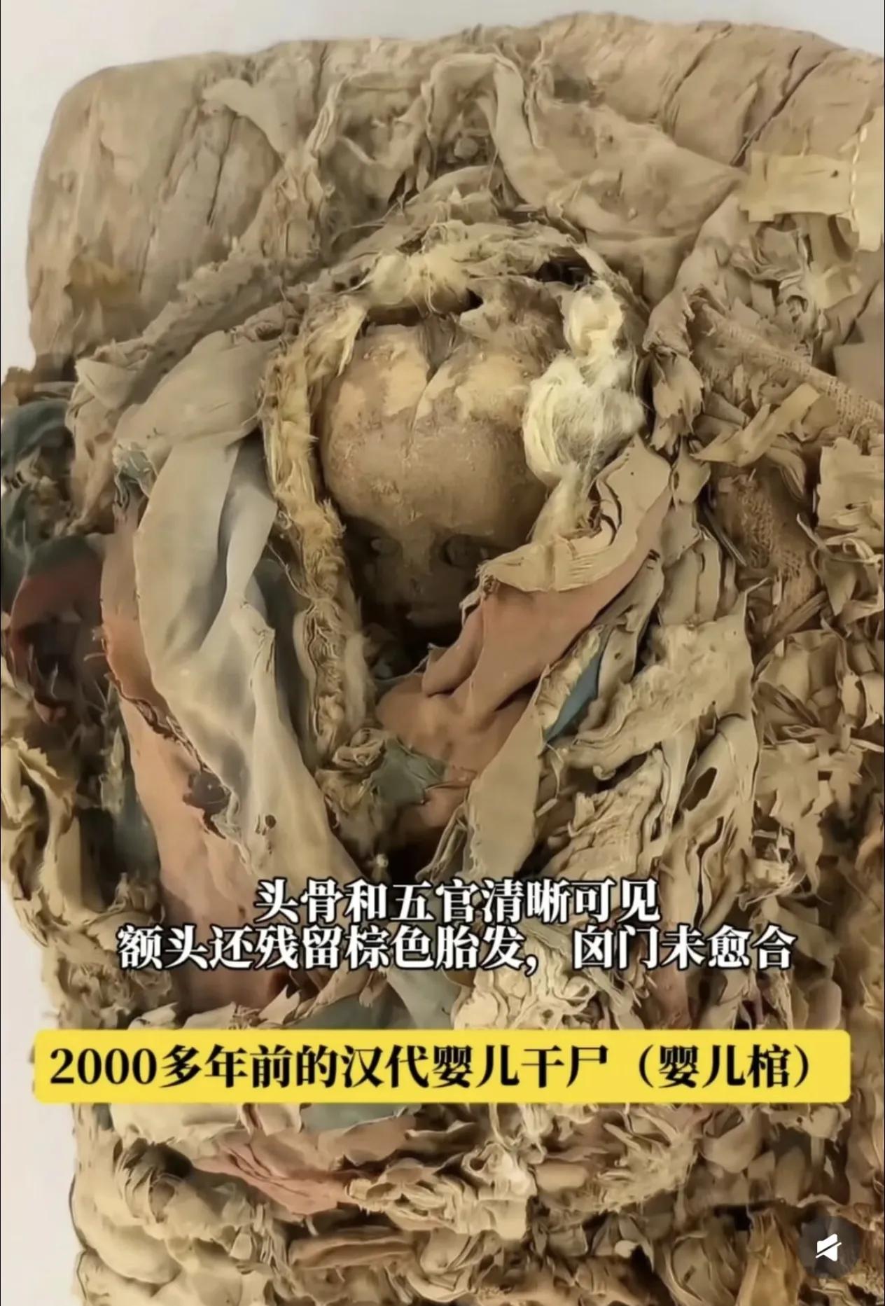 这是一具汉代婴儿干尸，宝宝离开人世时，才仅仅1-2个月大。
 
头骨五官依旧清晰