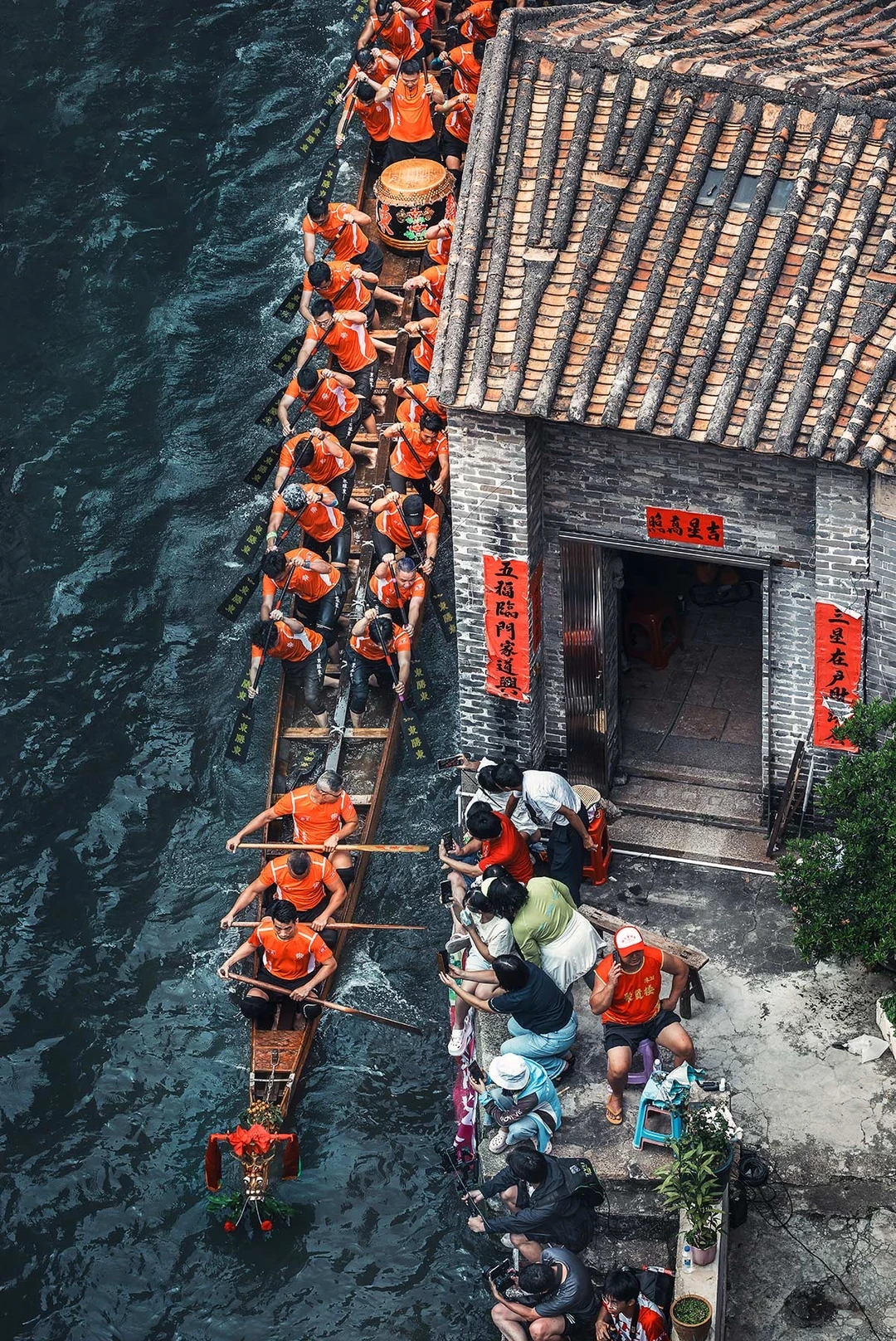 青瓦老屋傍绿水，龙舟破浪穿巷来