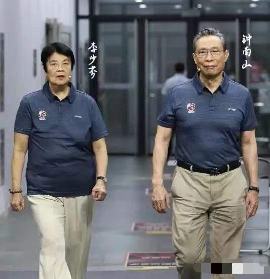 钟南山院士与夫人李少芬幸福同框 ，两人都穿着藏兰色T恤，卡其色长裤，夫人李少芬一