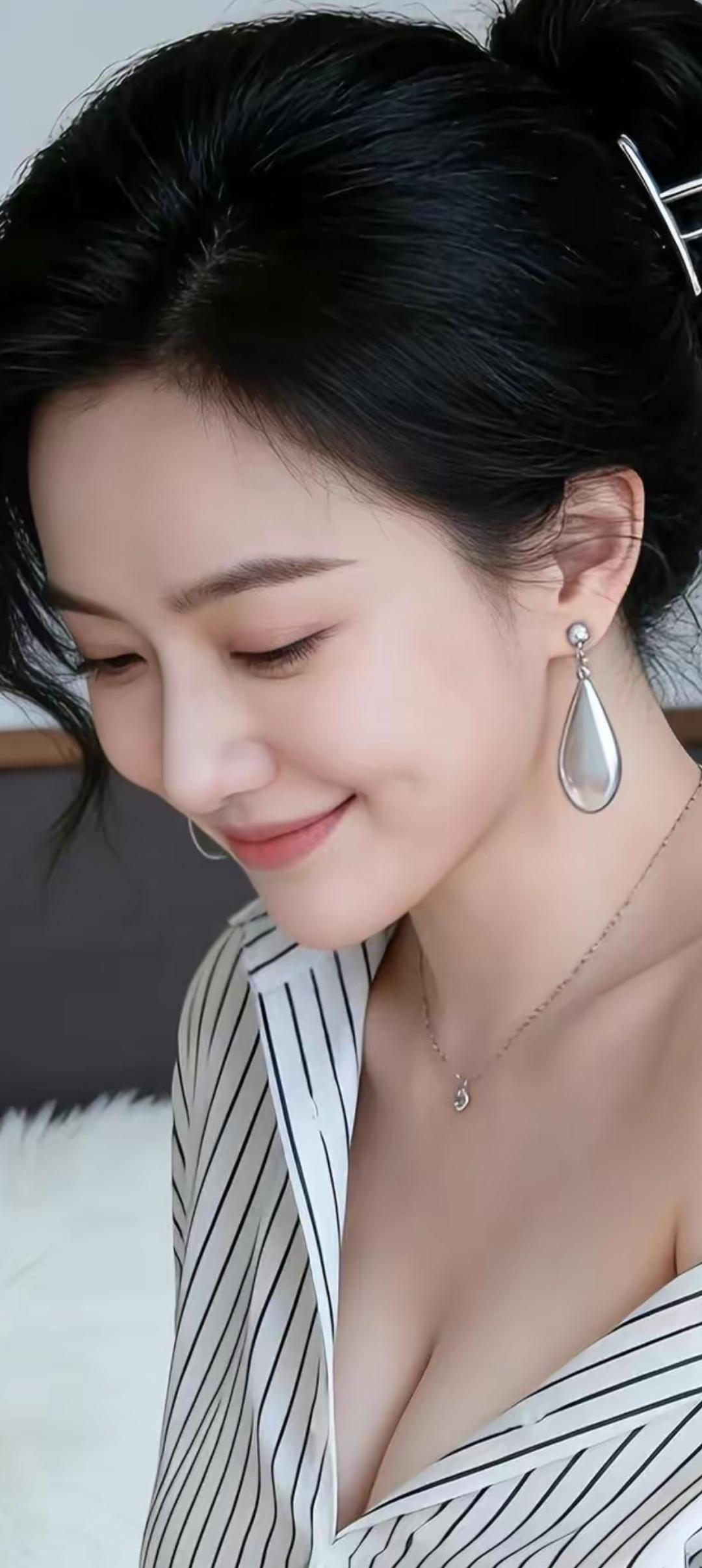 优雅黑发，迷人微笑，时尚耳环，精致项链，黑白条纹衬衫，简约而时尚。