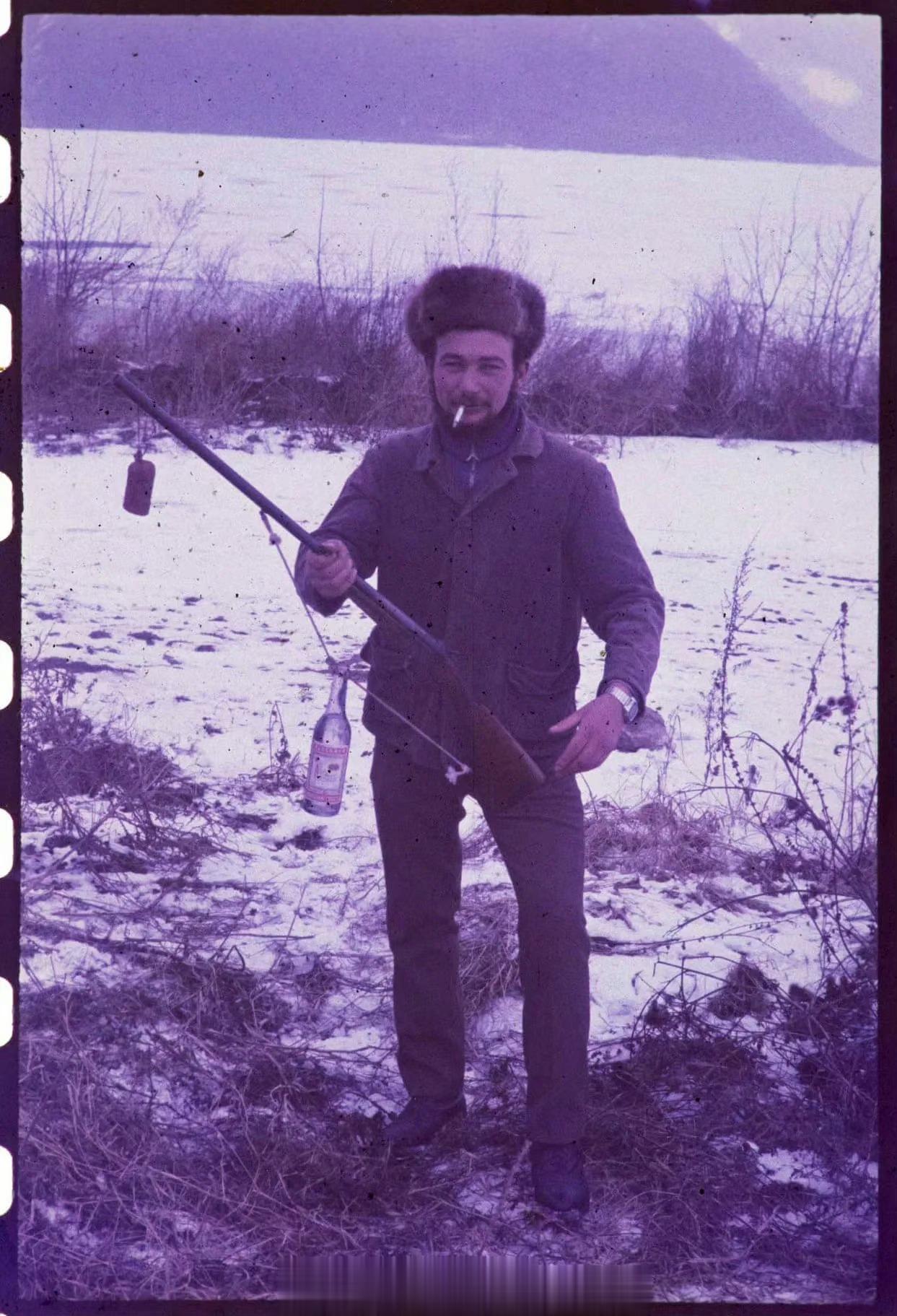 1963年，乌克兰。基辅郊外的猎人，冰天雪地里他嘴叼着烟，枪绳上吊着瓶87度的伏