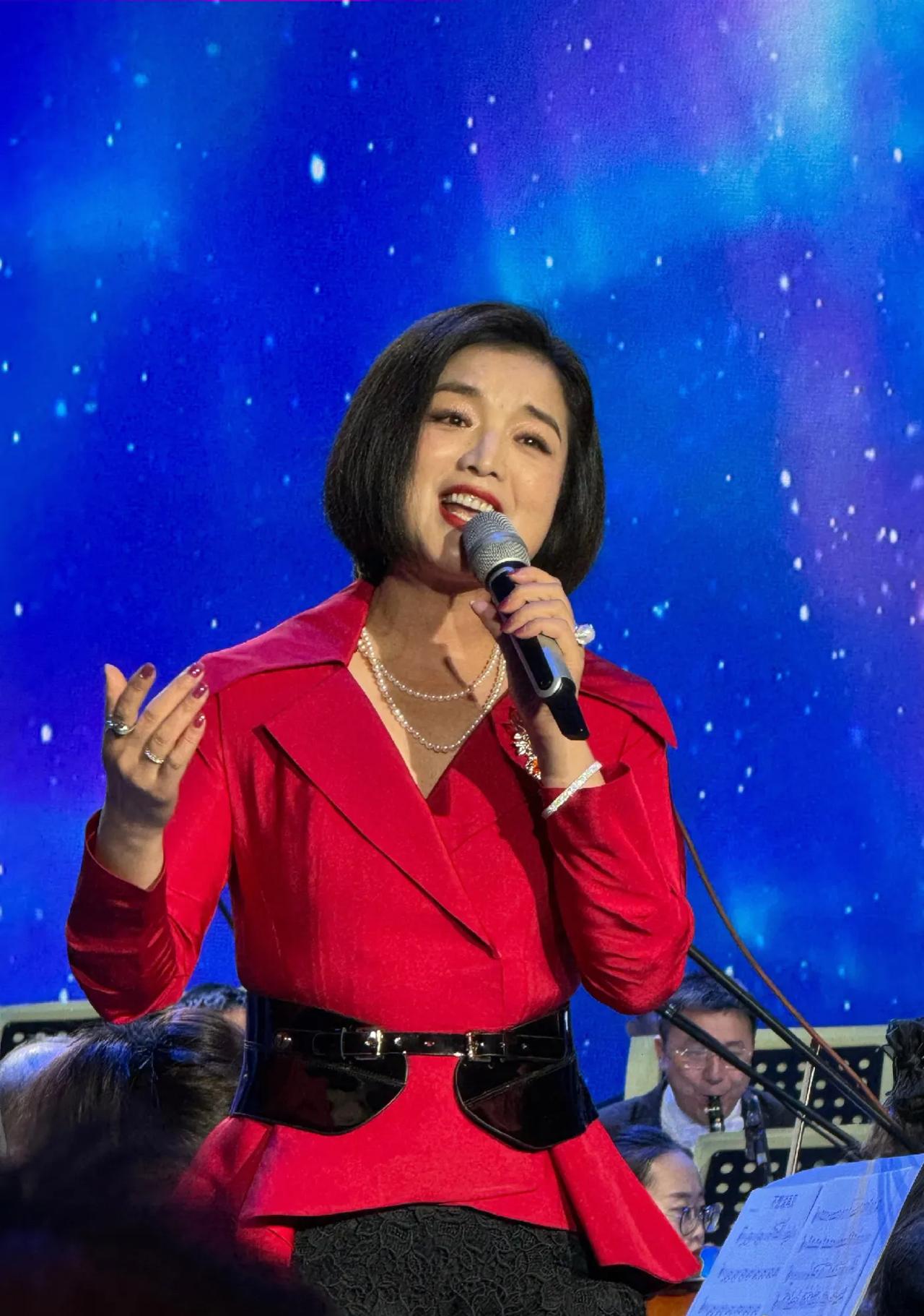白雪晒演出照，配文:演出成功。舞台上，白雪身穿红色外套搭配黑色半身裙，优雅知性。