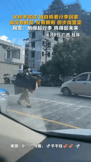 人未出校门，身已立天下！

高考结束，女孩一个人担着行李步行回家，无人伴考，无人