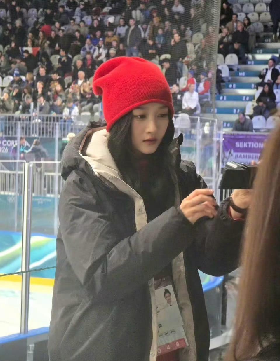 米兰偶遇，戴着红色针织帽、裹着黑色羽绒服，现身冰球比赛现场，状态松弛又自在，冬奥