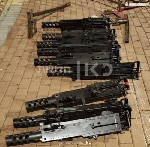 以色列军队在该国北部地区使用军用卡车搬运武器时，数十件重机枪部件从车上散落到道路