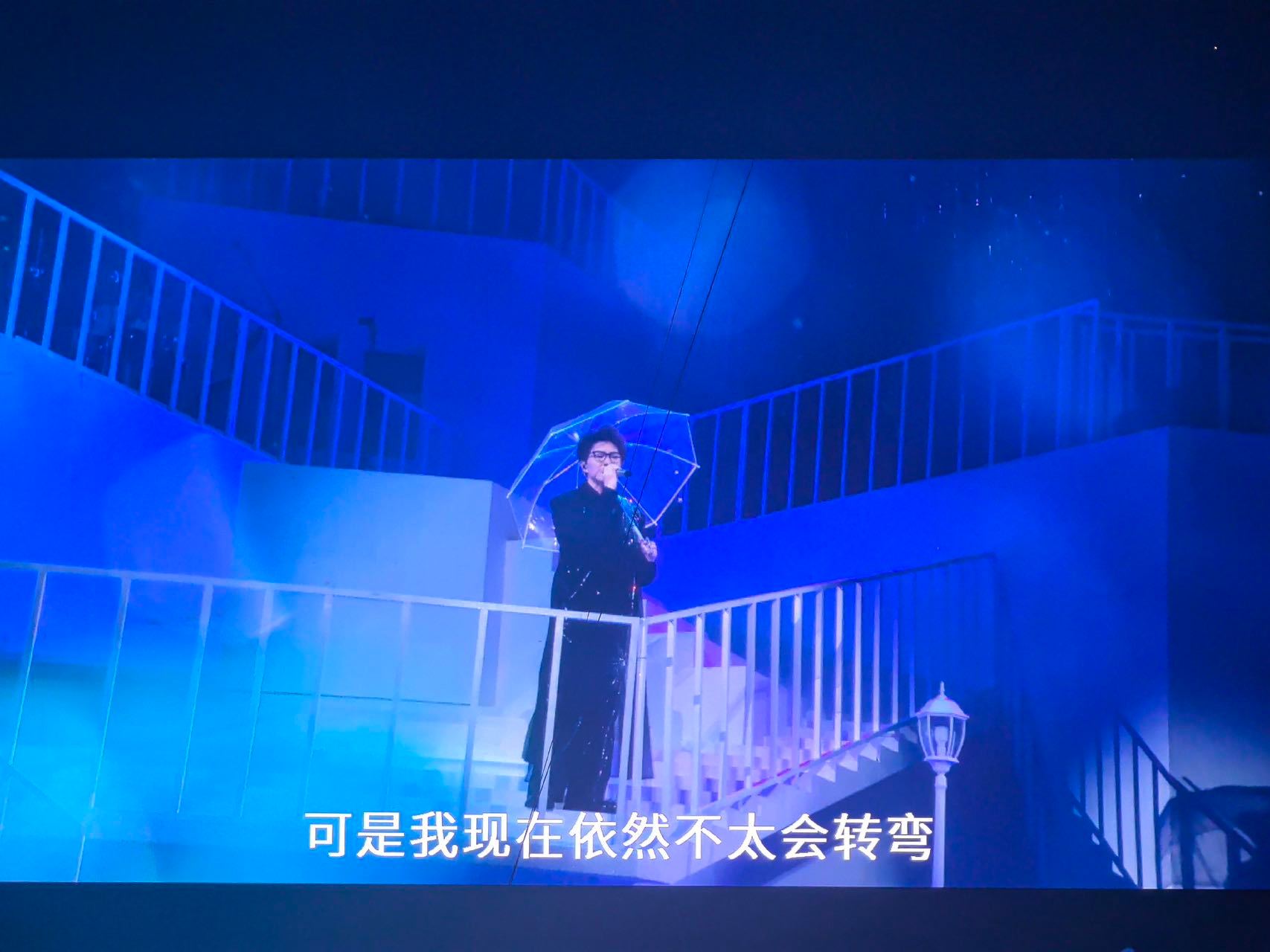 毛不易北京中秋场大雨，左手撑伞稳如老狗。粉丝笑疯：多余？不存在的，大雨按住的左手