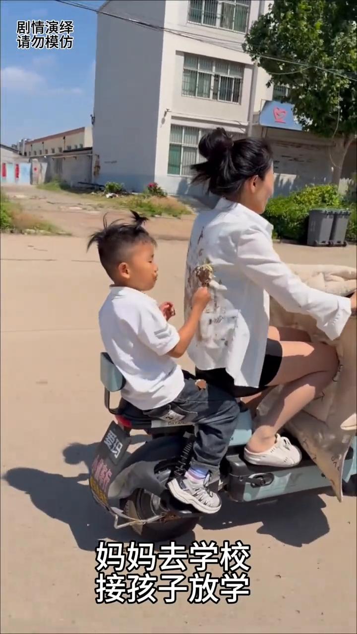 妈妈去学校接孩子放学，谁知男孩嚷着要吃冰激凌，就这样儿子在车上吃着冰激凌，殊不知