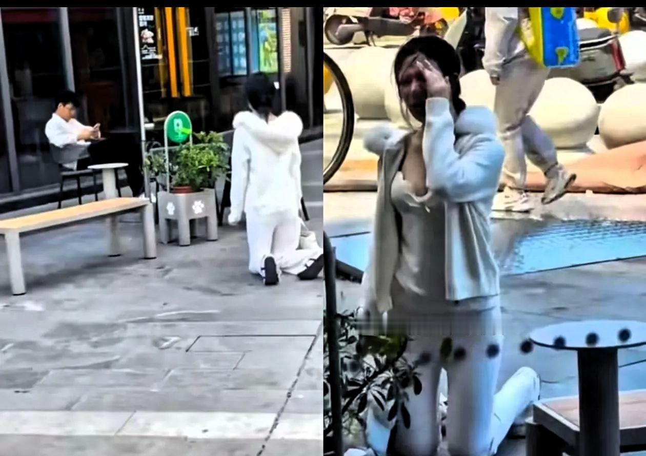 上海，5月16日，一个有些袒胸露乳的年轻姑娘，当街跪在一个男子面前，男子坐椅子上