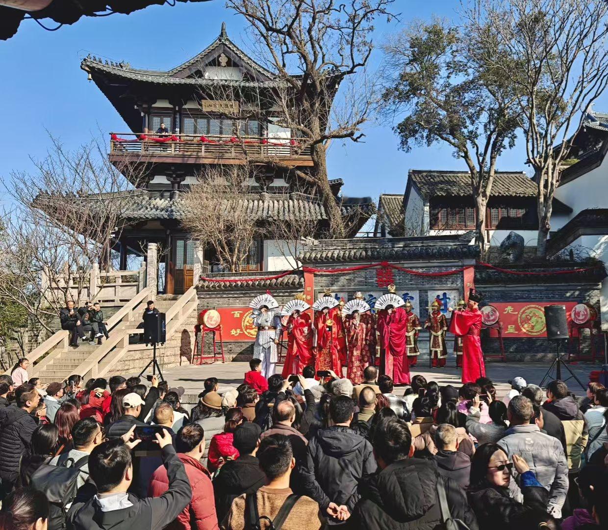 2. 镇江的春日里，楼台见证盛景，人群共赴欢喜。传统的韵味，在这熙攘中愈发鲜活。