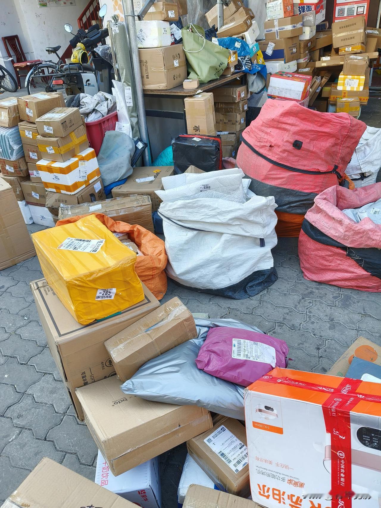 清晨的街道上，快递包裹已堆成了小山，纸箱、布袋裹着棕、黄、粉、灰的色调，在冬日里