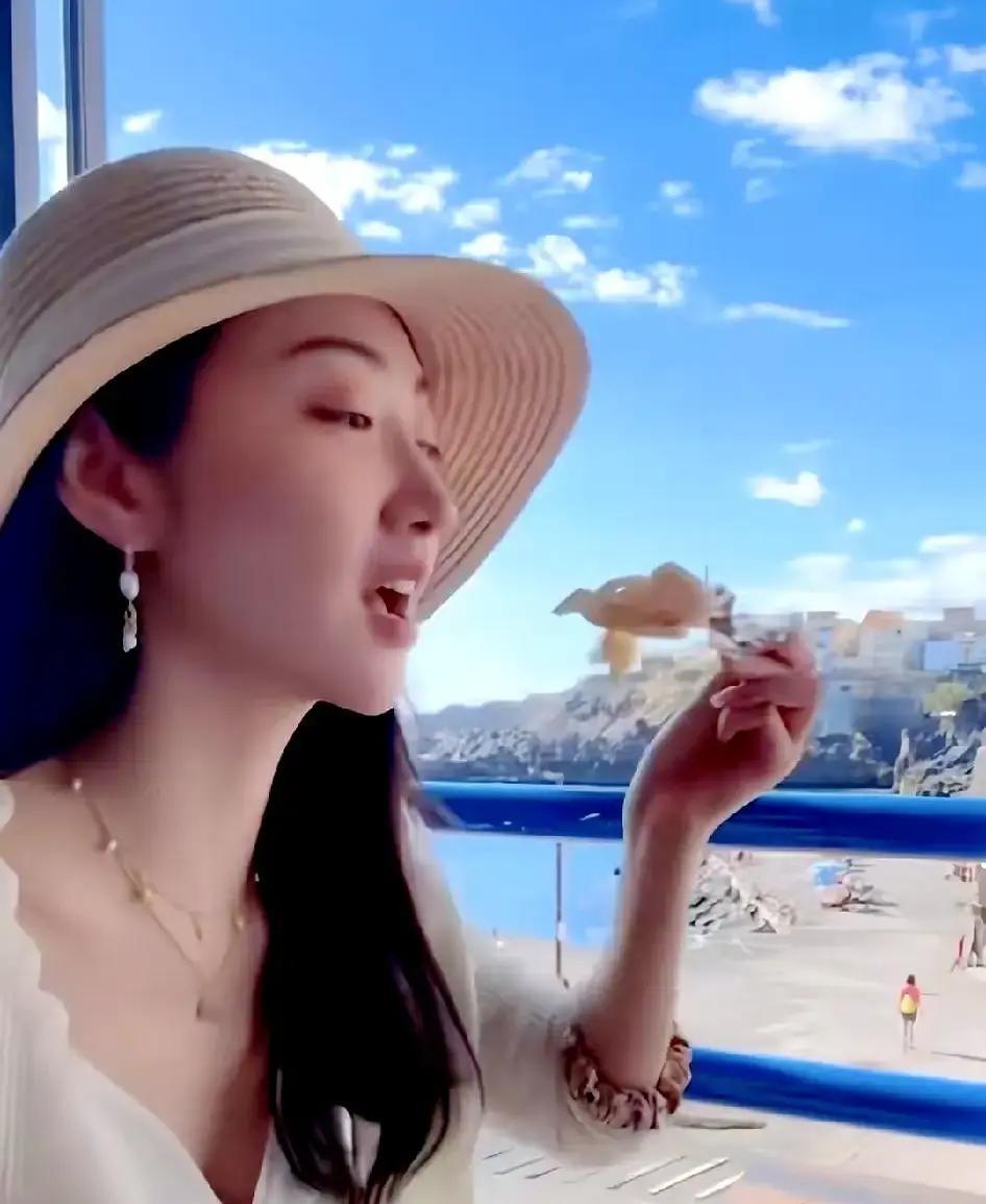 景甜端起一盘比成年人小臂还长的海鲜拼盘怼到手机镜头前，这是她在马尔代夫水上别墅里
