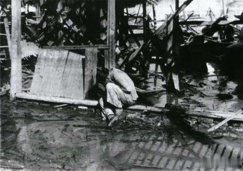 1938年，汉口，一位妇女在被日军炸毁的家的废墟中哭泣 