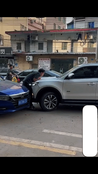 一名男子因为车辆擦挂，和白车车主发生口角，直接堵在白车面前让白车撞他，没想到白车
