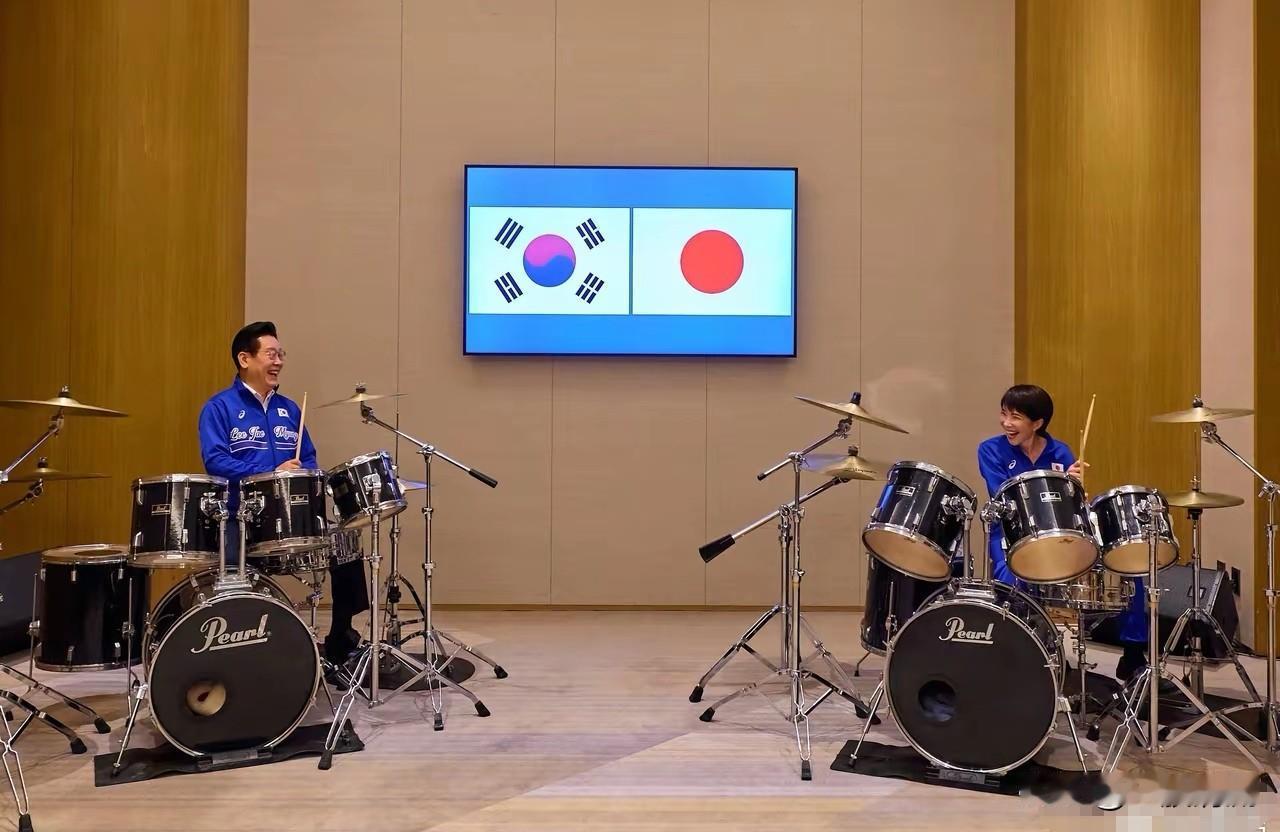 韩日两国领导人
一起玩的挺花哨
你看他们
着同款颜色服装
同打一样的架子鼓
看起