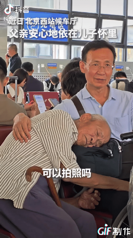 上人民日报了。北京西站候车厅，一位年迈的父亲旅途疲惫，安心地依偎在儿子的怀里睡觉
