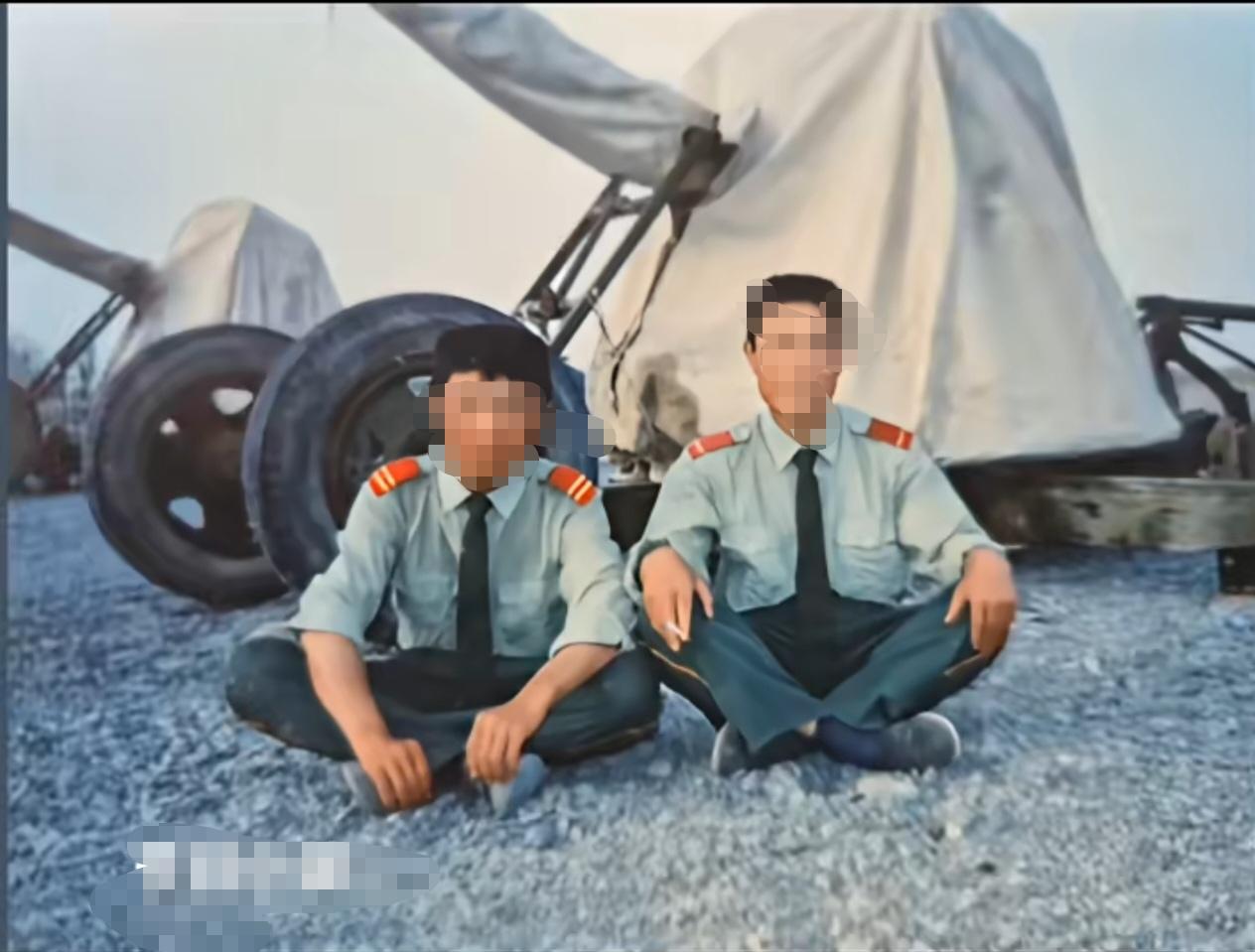 武警战士背后的65式37毫米双管高射炮！一张有意思的照片，两名武警战士盘坐在地上