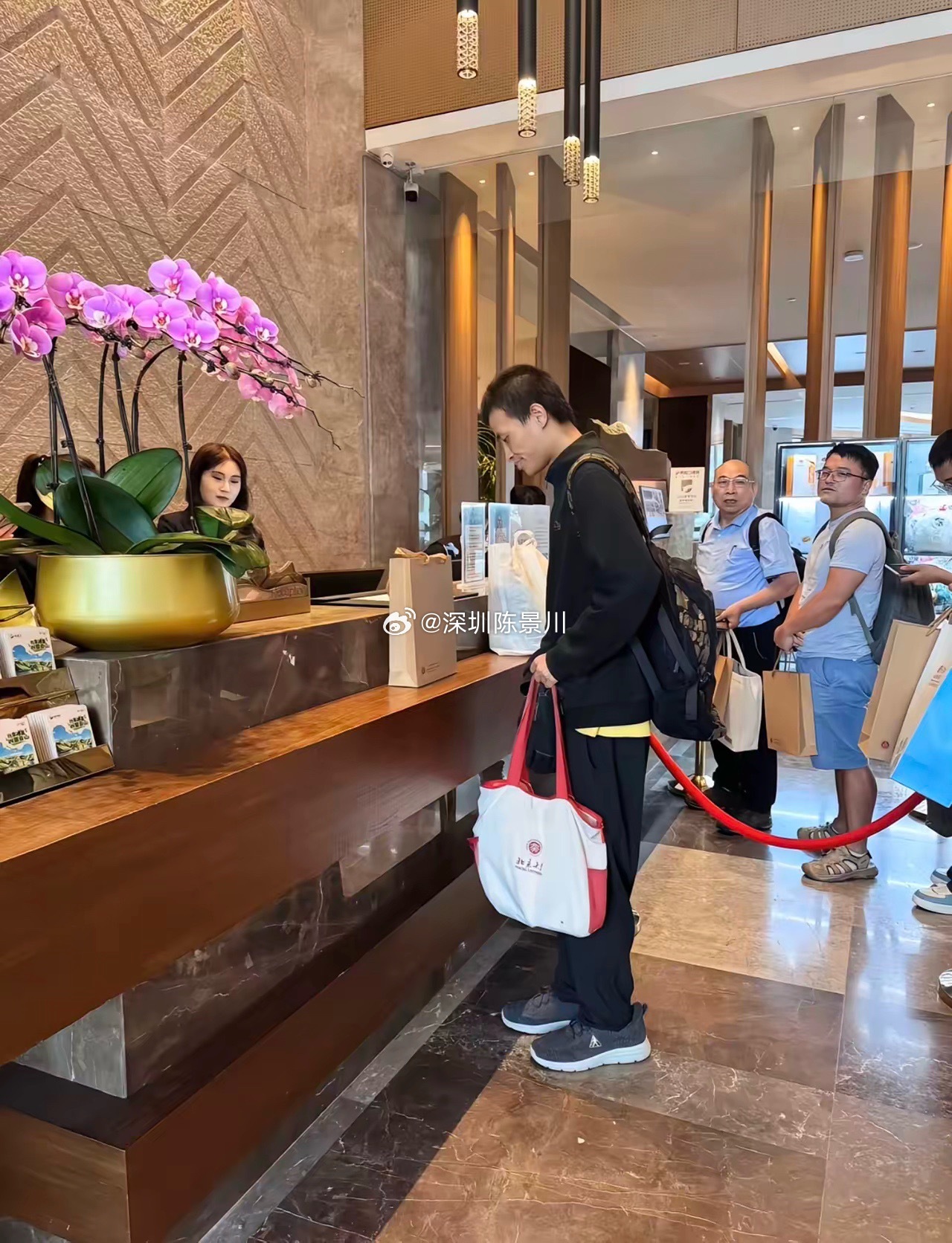 35岁韦东奕“韦神”在崇礼酒店大堂办理入住，背着大包参加数学活动，没有行李箱，拿