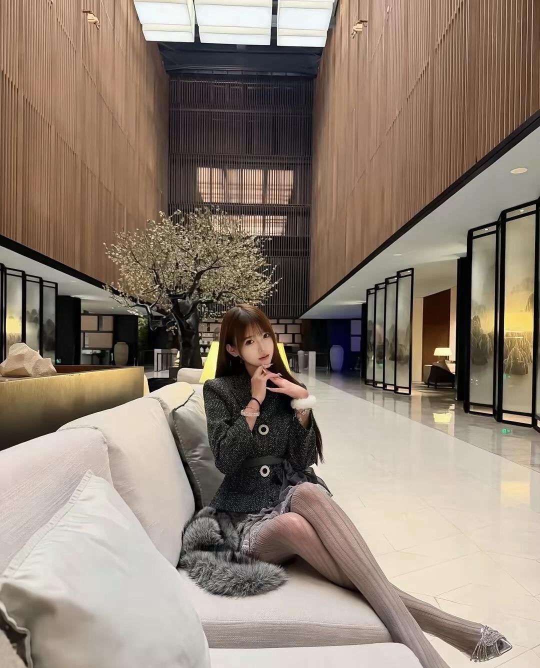 公司销冠优雅坐于现代大堂，黑白灰穿搭尽显时尚魅力