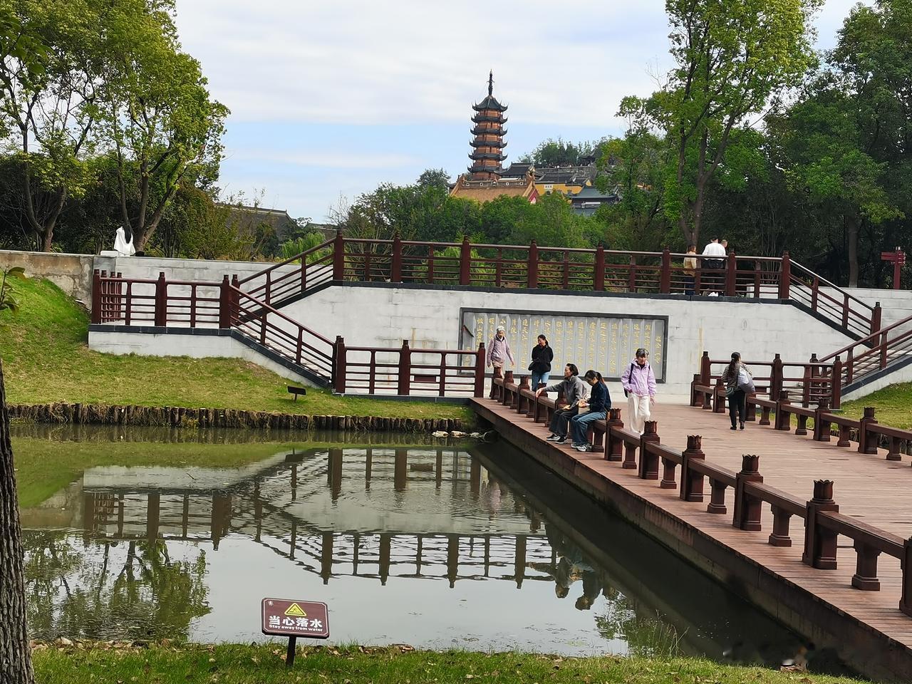 晒图笔记大赛镇江金山寺一景：碧水映古塔，木桥揽清风。漫步林间步道，远处古塔藏在浓