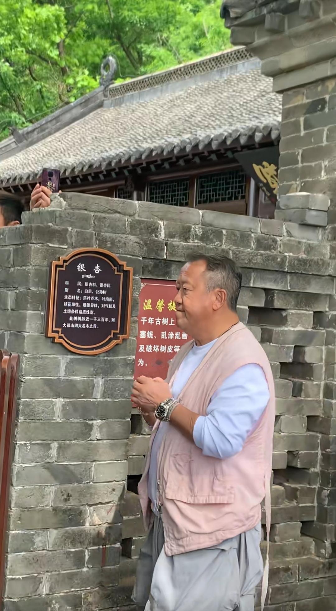 这位大叔在古宅前看介绍牌。在一景区偶遇，看着很面熟，这是谁来？有认识的吗？