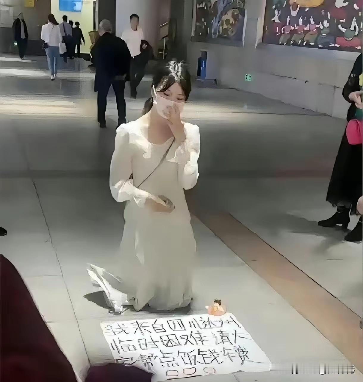 穿白连衣裙的女孩，跪在地上求助，这是真的吗？

在城市街头，夜幕已经降临，街上人