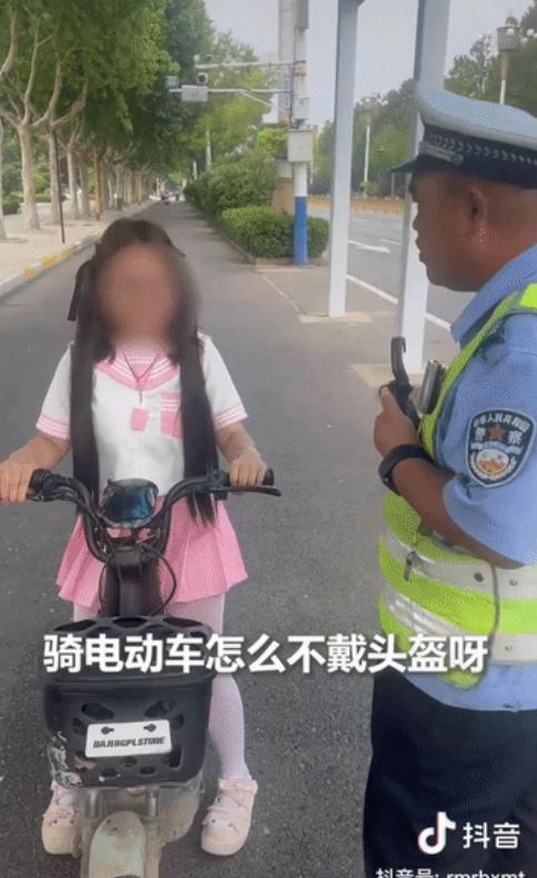 河北，一名小女孩骑着电动车上路，被交警拦下："怎么不戴头盔？"哪料小女孩灵机一动